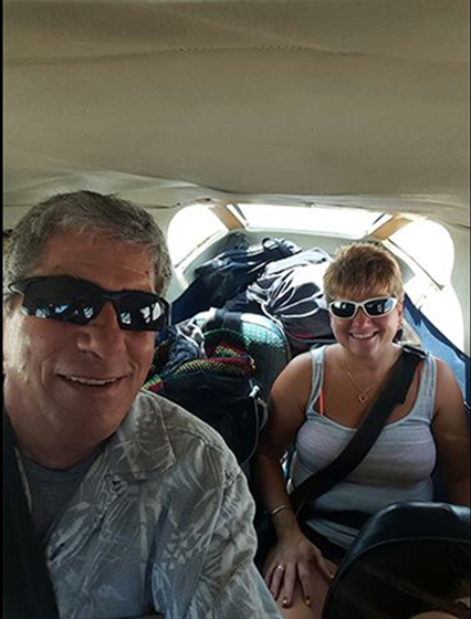 Renee' and husband Myles in a small airplane in 2015