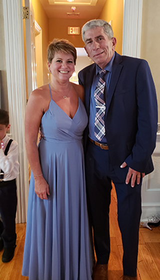 Renee' and husband Myles dressed for a wedding 2018