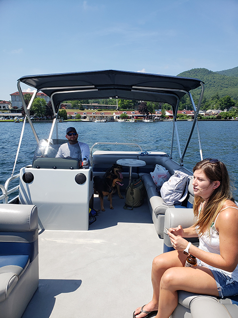 A young man and young woman on a pontoon boat